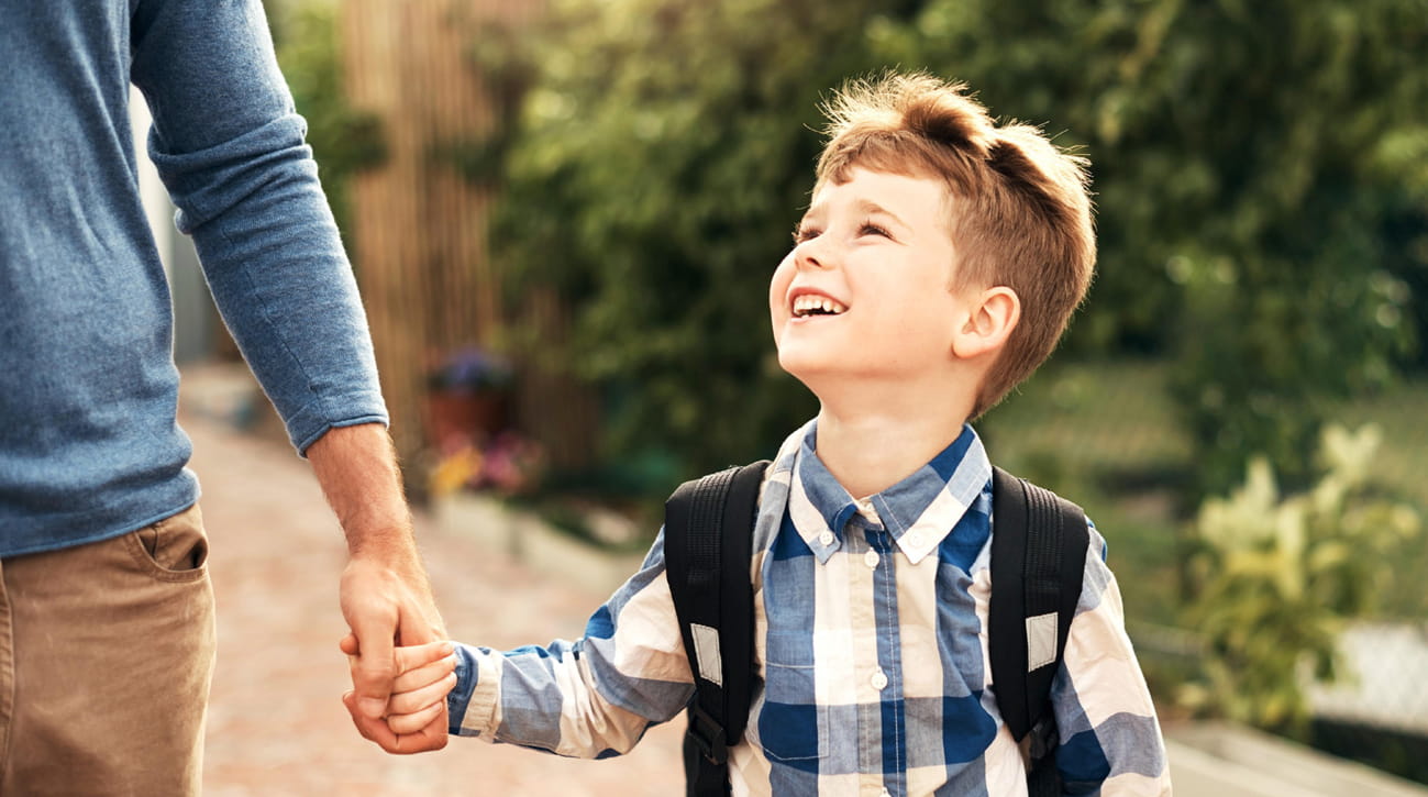 Boy holding parent's hand